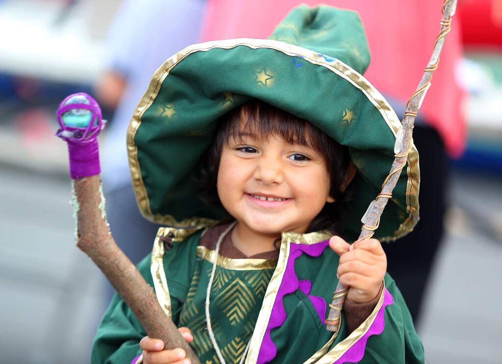 Caspian Padua, 2, dresses up like a wizard during the final night of the Barlow Street Fair in Sebastopol, Thursday, October 30, 2014. (Crista Jeremiason / The Press Democrat)