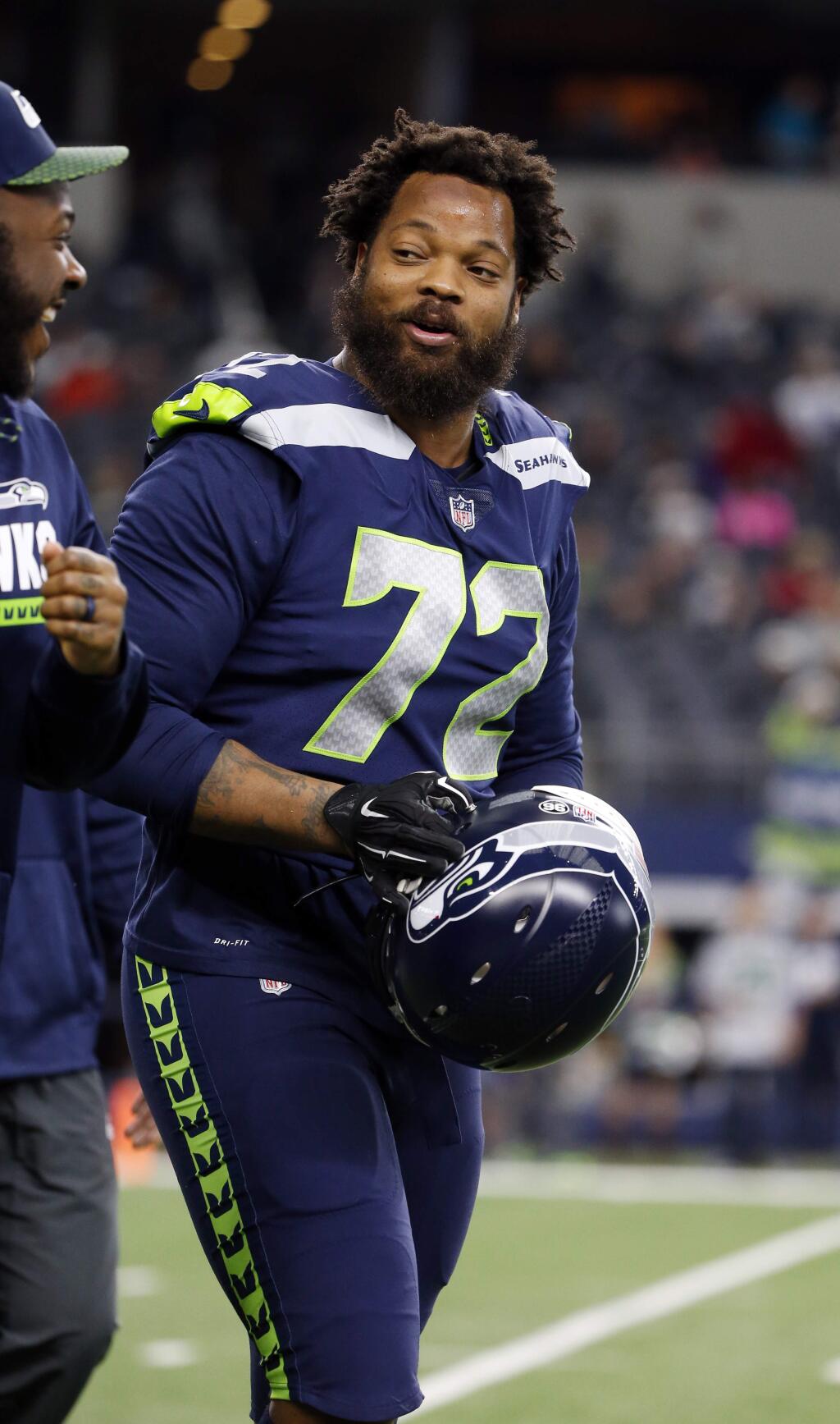 Seattle Seahawks defensive end Michael Bennett walks on the field prior to a game against the Dallas Cowboys, Sunday, Dec. 24, 2017, in Arlington, Texas. (AP Photo/Michael Ainsworth)