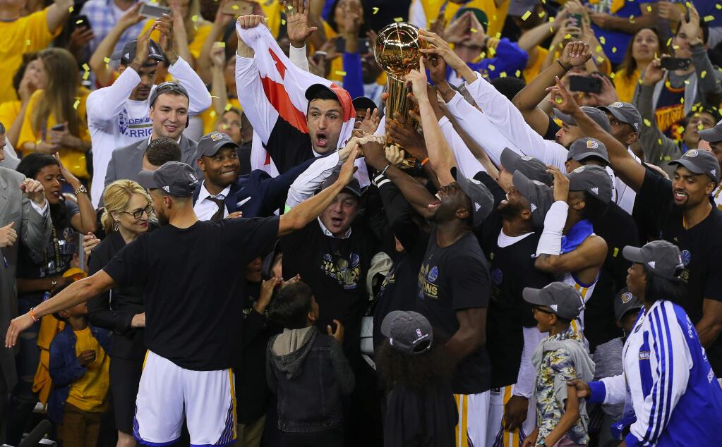 The Golden State Warriors celebrate their second NBA championship in three seasons Monday in Oakland. (CHRISTOPHER CHUNG / The Press Democrat)