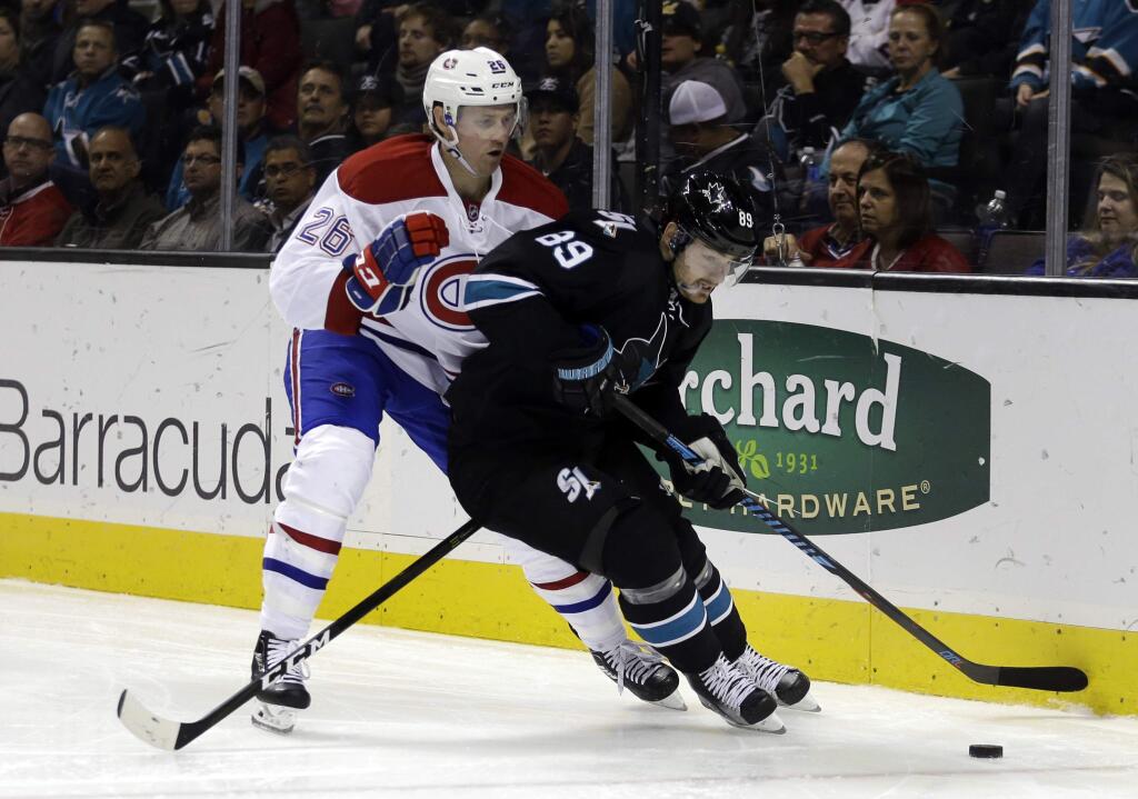 The Montreal Canadiens' Jeff Petry, left, and the San Jose Sharks' Mikkel Boedker fight for the puck during the third period Friday, Dec. 2, 2016, in San Jose. The Sharks won 2-1. (AP Photo/Ben Margot)