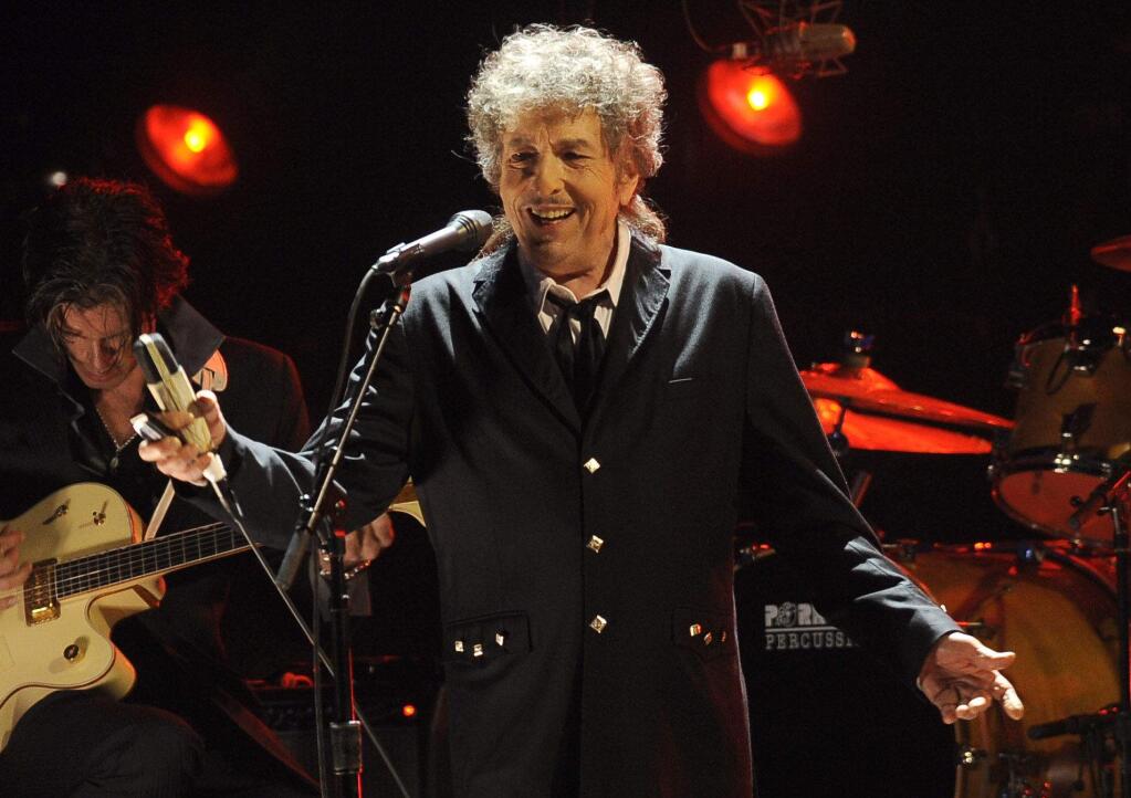 FILE - In this Jan. 12, 2012, file photo, Bob Dylan performs in Los Angeles. Goldenvoice announced Tuesday, May 3, 2016, that the Rolling Stones, Dylan, Paul McCartney, Neil Young, Roger Waters and the Who will perform during a three-day concert at the desert grounds where the annual Coachella music festival is held. (AP Photo/Chris Pizzello, File)