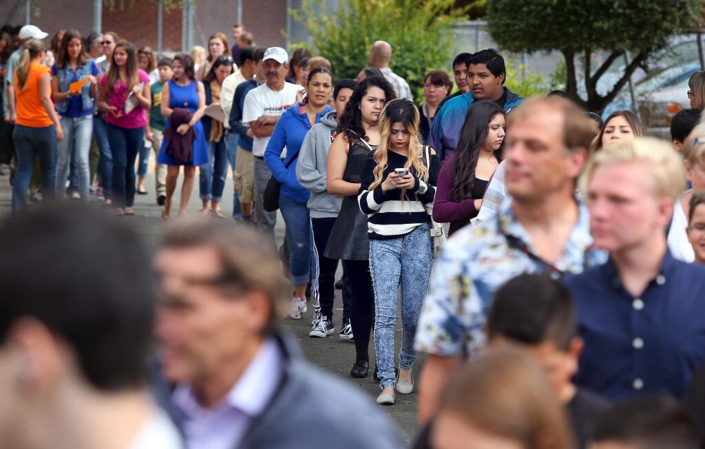Incoming freshmen and their parents line up during orientation at Santa Rosa High School in Santa Rosa on Wednesday, Aug. 13, 2014. (Christopher Chung / The Press Democrat)