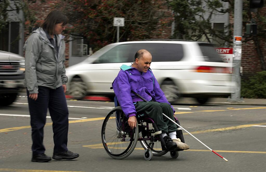 Ken Rossi crosses a busy intersection with occupational therapist Kathy Karlen. (John Burgess / PD FILE 2006)