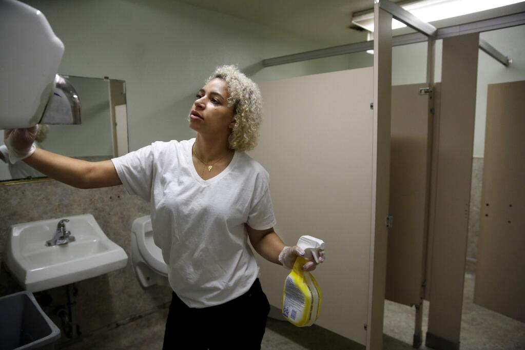 Audrianna Jones, manager of St. Vincent de Paul Society's Community Kitchen, wipes down the restrooms with bleach as a precautionary measure against Coronavirus in Santa Rosa on Tuesday, March 10, 2020. (BETH SCHLANKER/ The Press Democrat)