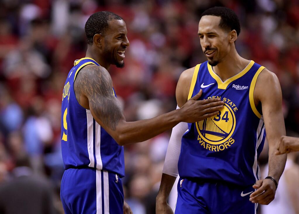 Golden State Warriors forward Andre Iguodala (9) and teammate Shaun Livingston (34) celebrate their win against the Toronto Raptors following the second half of Game 2 of basketball‚Äôs NBA Finals, Sunday, June 2, 2019, in Toronto. (Frank Gunn/The Canadian Press via AP)
