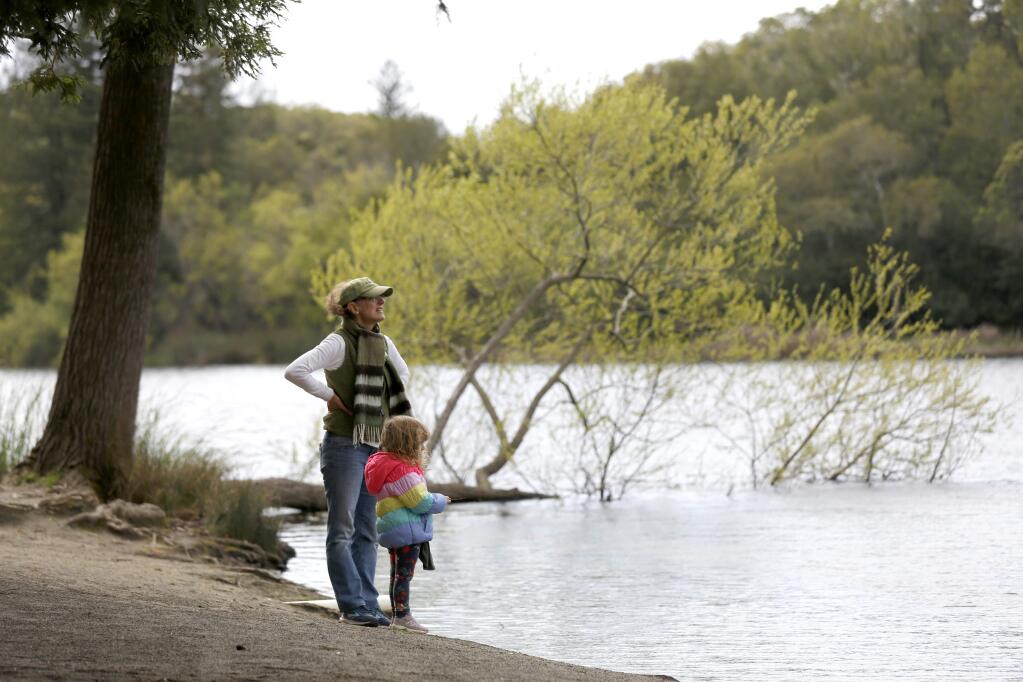 Michele Methum and daughter, Stella, 3, look out across the water at Spring Lake Regional Park in Santa Rosa on Monday, March 23, 2020. (BETH SCHLANKER/ The Press Democrat)