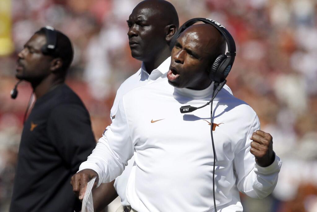 FILE - In this Oct. 8, 2016, file photo, Texas head coach Charlie Strong reacts to a play during an NCAA college football game against Oklahoma in Dallas. Simpler and louder have meant better so far at Texas and Notre Dame, with both head coaches taking more hands-on roles to fix bad defenses after replacing coordinators. The two traditional powers are showing improvement after making changes at defensive coordinator, although both are stills works in progress. (AP Photo/LM Otero, File)