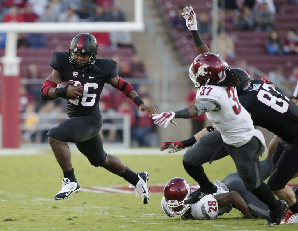 Stanford running back Barry Sanders (26) runs against Washington State during the first half of an NCAA college football game on Friday, Oct. 10, 2014, in Stanford. (AP Photo/Marcio Jose Sanchez)