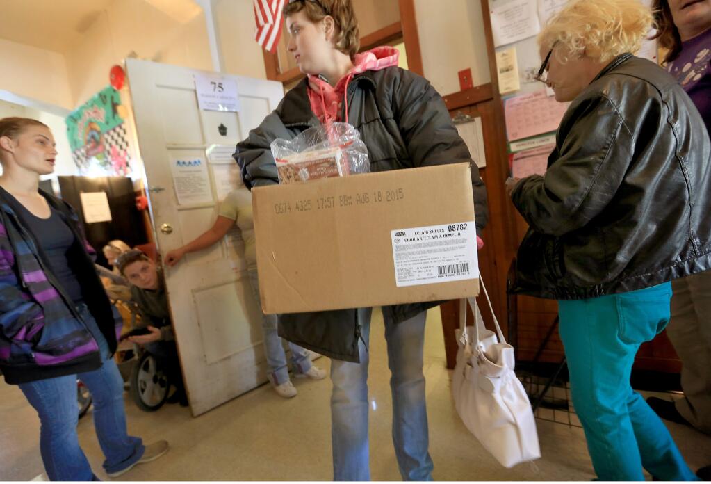 Kristal McCutcheon of Nice exits with a box of groceries from the Lucerne Alpine Senior Center food pantry, Friday Feb. 20, 2015, to help tide her over until the end of the month. Lake County is one of the poorest counties in California. (Kent Porter / Press Democrat) 2015