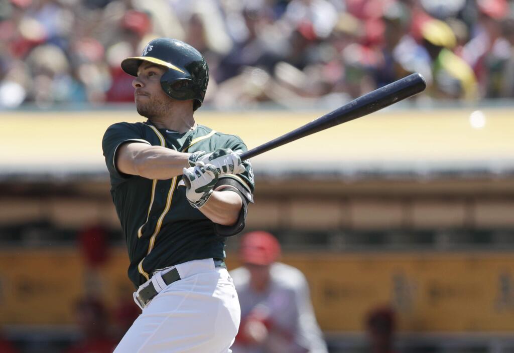 Oakland Athletics' Danny Valencia watches his two-run home run against the Los Angeles Angels during the first inning of a baseball game Monday, Sept. 5, 2016, in Oakland, Calif. (AP Photo/Marcio Jose Sanchez)