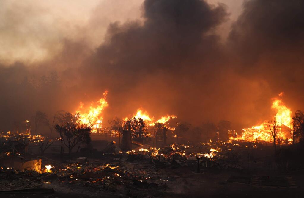 Structures in Fountaingrove burn on Oct. 9. (CHRISTOPHER CHUNG / The Press Democrat)