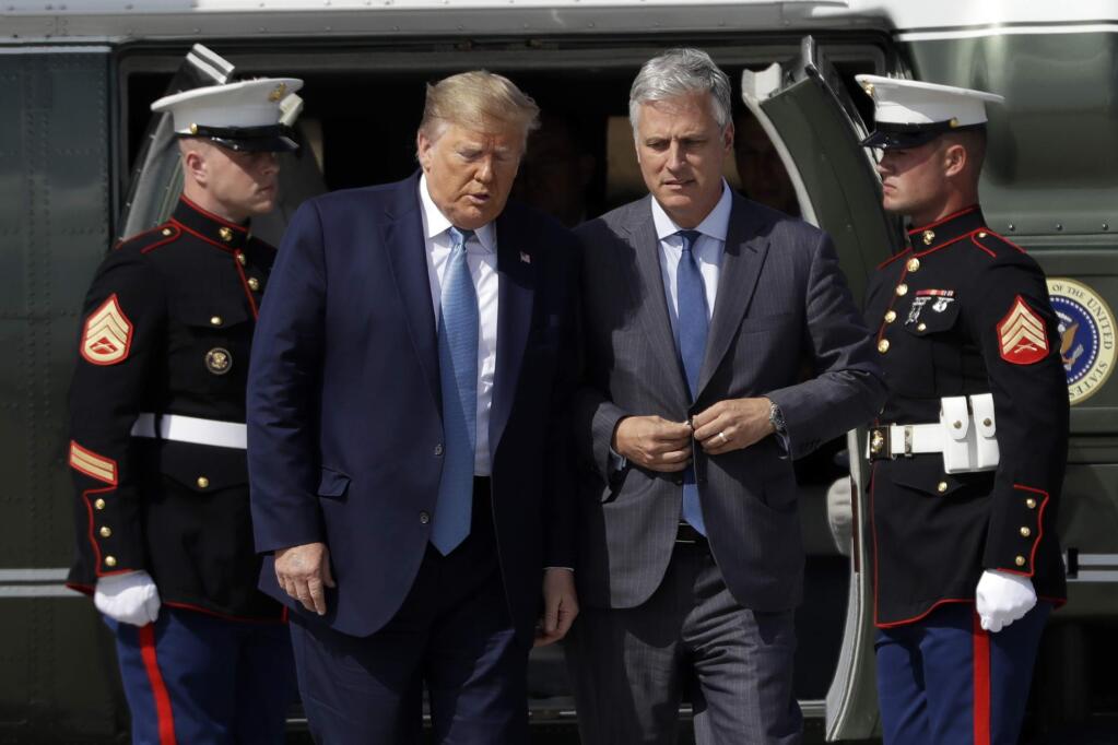 President Donald Trump walks Robert O'Brien, just named as the new national security adviser, at Los Angeles International Airport, Wednesday, Sept. 18, 2019, in Los Angeles. (AP Photo/Evan Vucci)