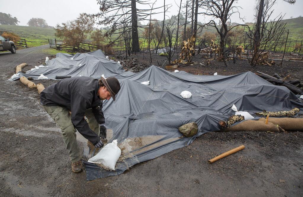 Community Soil co-founder Paolo Tantarelli used plastic to cover parts of a Brooks Rd. home burned in the Kincade Fire. The company is working with Russian Riverkeeper and the Sonoma Ecology Center on erosion control and toxics containment on properties destroyed by the Kincade fire. (photo by John Burgess/The Press Democrat)