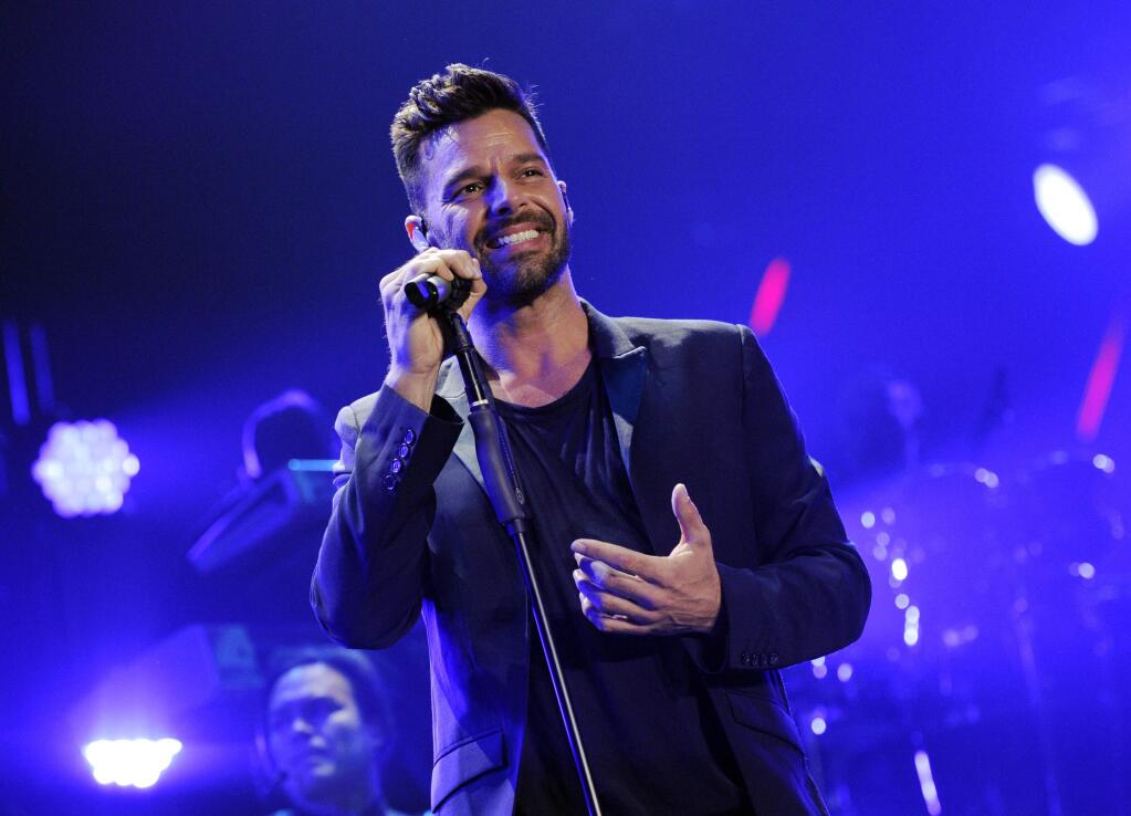 FILE - In this Nov. 22, 2014 file photo, Ricky Martin performs at the iHeart Radio Fiesta Latina concert in Inglewood, Calif. Martin responded to the Supreme Court's ruling on Friday, June 26, that same-sex couples have a right to marry anywhere in the United States, by tweeting, “Ahora en los EEUU no se llamara 'matrimonio igualitario' se llamara MATRIMONIO y punto.” (“Now in the U.S. it won't be “marriage equality” it will only be MARRIAGE.)” The ruling is a historic culmination of decades of litigation over gay marriage and gay rights generally. Gay and lesbian couples already could marry in 36 states and the District of Columbia. The court's 5-4 ruling means the remaining 14 states, in the South and Midwest, will have to stop enforcing their bans on same-sex marriage. (Photo by Chris Pizzello/Invision/AP, File)