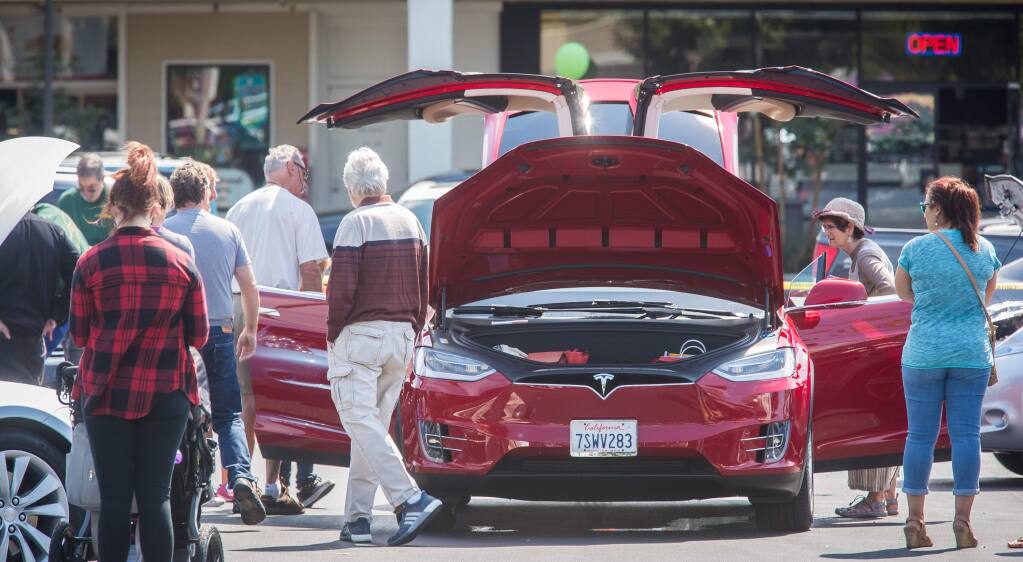 Guests check out a Tesla Model X during an event promoting electric vehicles at Coddingtown Mall in Santa Rosa, Sunday, Sept. 11, 2016. (Jeremy Portje / For The Press Democrat)