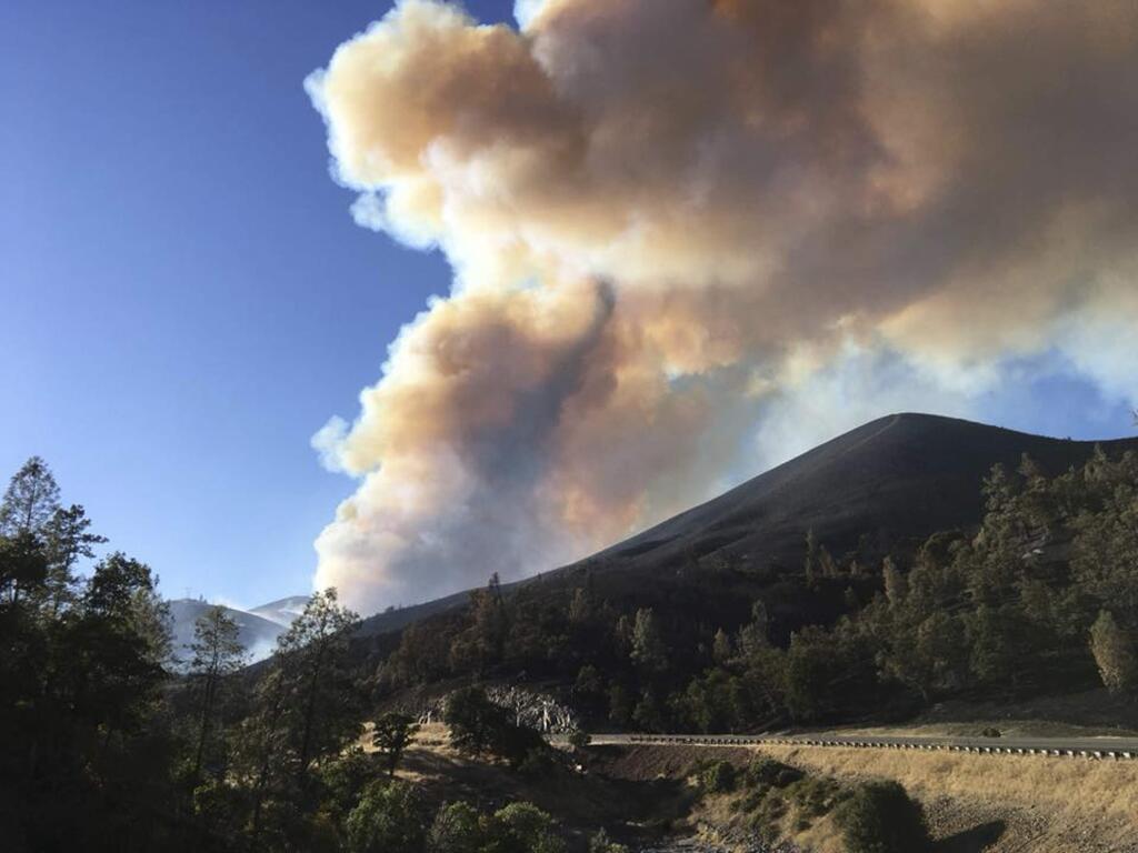 In this photo provided by the California Highway Patrol smokes rises Thursday, July 26, 2018, from a fire near Redding, Calif. The fire is one of several across California amid a heat wave that has seen days of triple-digit temperatures. (California Highway Patrol via AP)