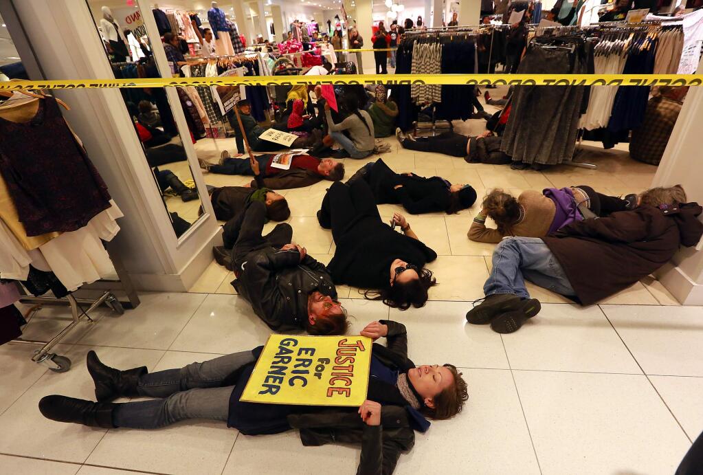 About 70 protesters 'die-in' at Forever 21 in the Santa Rosa Plaza on Saturday afternoon to protest black teen killings at the hand of police across the country. (photo by John Burgess/The Press Democrat)