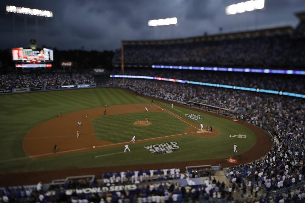In this image taken with a tilt/shift lens, the Los Angeles Dodgers play the Houston Astros in Game 7 of baseball's World Series Wednesday, Nov. 1, 2017, in Los Angeles. The Astros won 5-1 to win the series 4-3. (AP Photo/Matt Slocum)