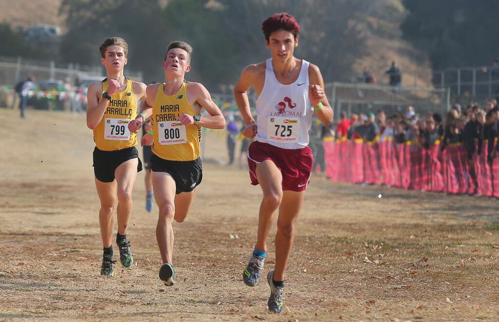 Maria Carrillo juniors Colton Swinth, center, and Rory Smail, left, race to a fourth and fifth-place finish respectively, behind third-place finisher Preston Norris, of Las Lomas, during the NCS Cross Country Championship division three boys race at Hayward High School on Tuesday, November 20, 2018. The Maria Carrillo boys team finished second to Campolino.(Christopher Chung/ The Press Democrat)