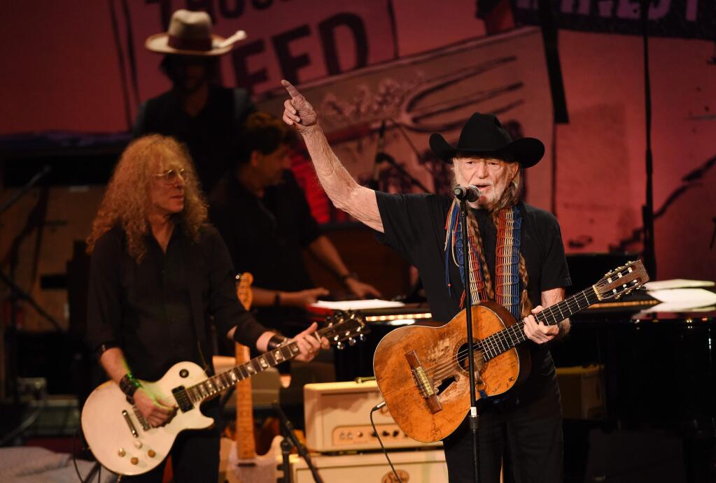 Willie Nelson, right, performs at the 17th Annual GRAMMY Foundation Legacy Concert at the Wilshire Ebell Theatre on Thursday, Feb. 5, 2015, in Los Angeles. (Photo by Chris Pizzello/Invision/AP)