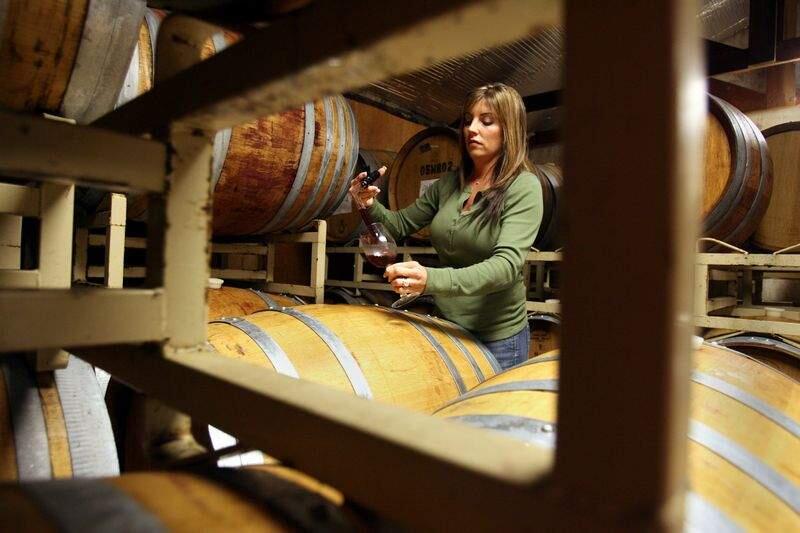 Tracy Dutton, owner of Dutton Estate Winery uses a wine thief to check on a barrel of 2006 Pinot Noir wine from Manzana vineyard in the barrel room of her Green Valley Road winery near Graton, CA on Friday February 9, 2007. Scott Manchester / The Press Democrat