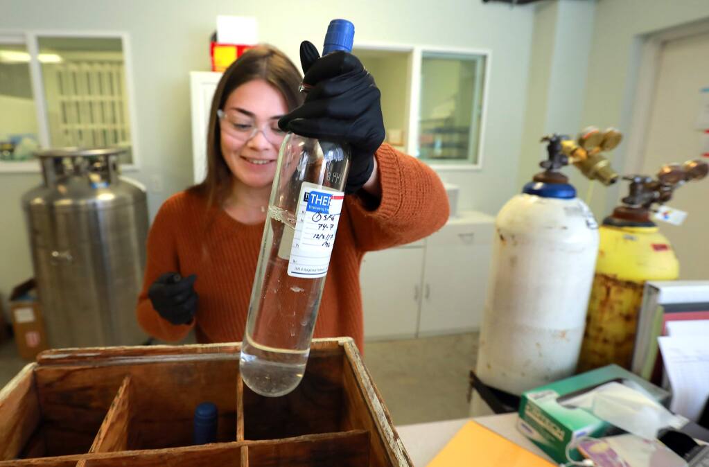 Thermochem intern Mariah Mesner fills gas samples with helium for analysis at the Santa Rosa company that supplies testing gear and services to geothermal companies in more than 20 countries. (photo by John Burgess/The Press Democrat)