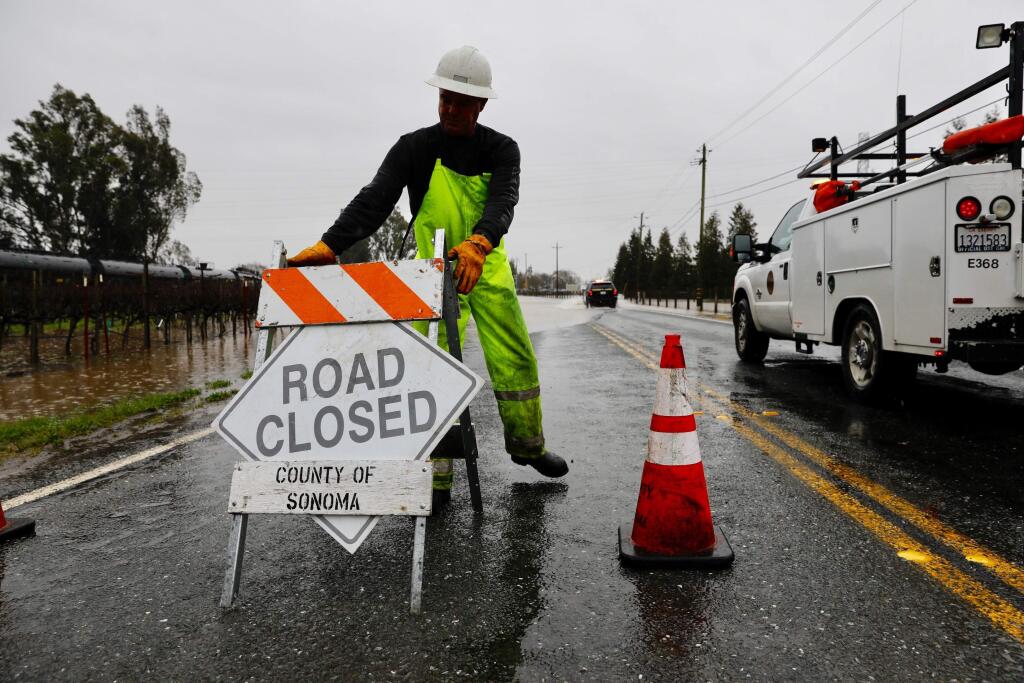 Sonoma County roads workers Todd Fourshay closes 8th Street East in Schellville on Tuesday, Feb. 26, 2019. (BETH SCHLANKER/ PD)