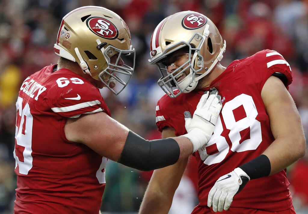 In this Dec. 16, 2018, file photo, San Francisco 49ers tight end Garrett Celek, right, is congratulated by offensive tackle Mike McGlinchey after scoring against the Seattle Seahawks in Santa Clara. (AP Photo/Tony Avelar, File)