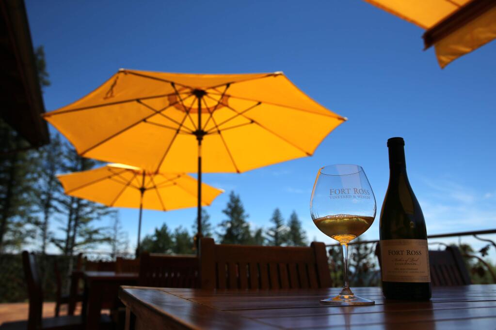 A glass and bottle of Chardonnay on the patio at Fort Ross Vineyard & Winery in Fort Ross on Wednesday, May 22, 2019. (BETH SCHLANKER/ The Press Democrat)
