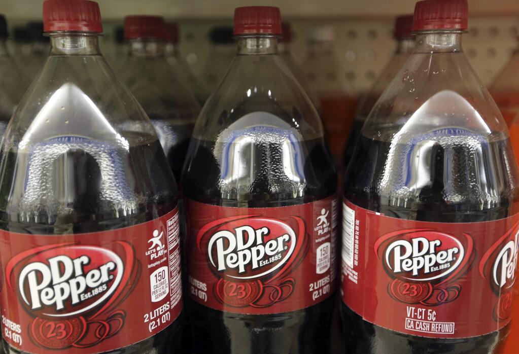FILE - This April 28, 2016, file photo shows bottles of Dr. Pepper on a store shelf at Quality Cash Market in Concord, N.H. Keurig is buying Dr. Pepper Snapple Group Inc. to create a beverage business with approximately $11 billion in annual sales, announced Monday, Jan. 29, 2018. (AP Photo/Jim Cole, File)