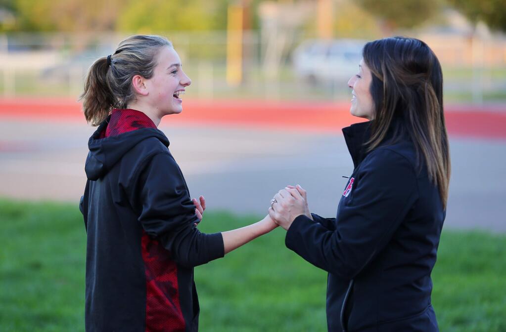 Healdsburg cross country standout Gabrielle Peterson, left, laughs with her coach, Kelly Blanchard, during practice in Healdsburg on Thursday, Nov. 17, 2016. (Christopher Chung / The Press Democrat)