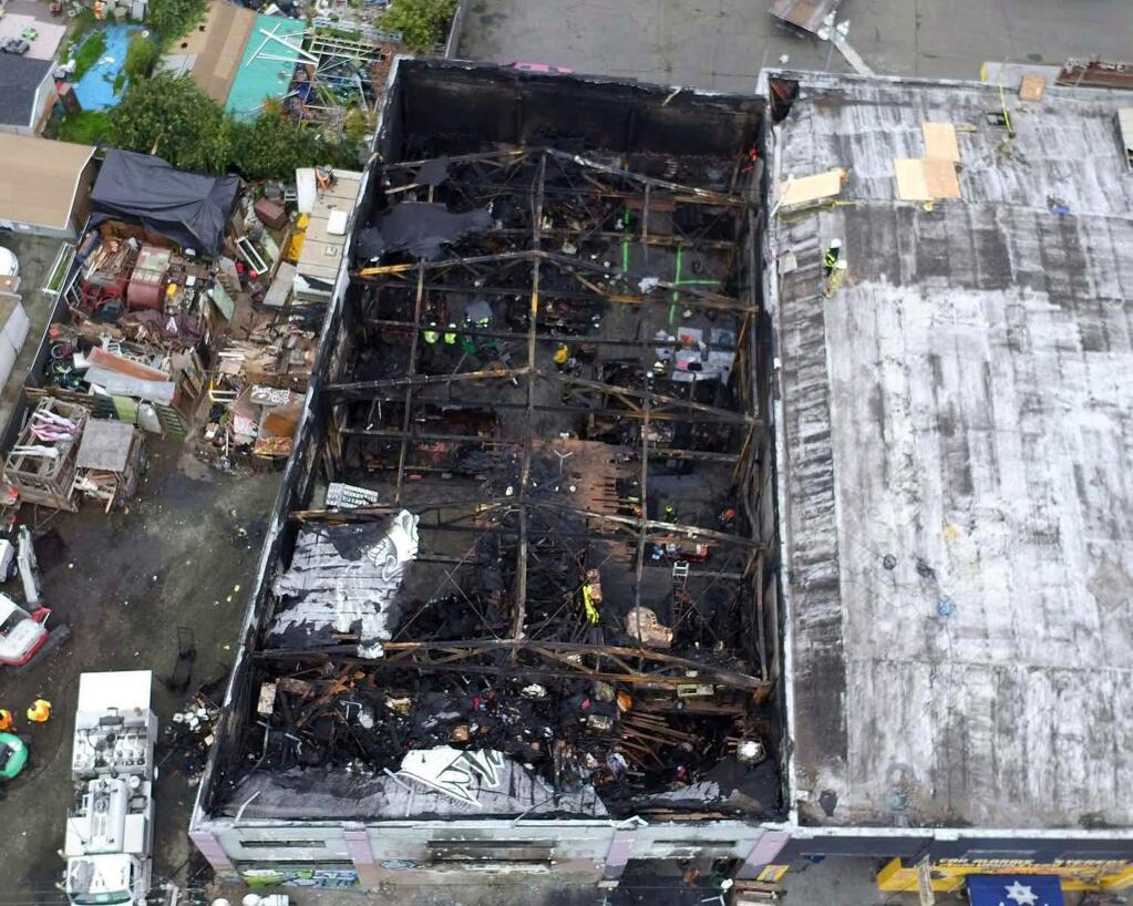 FILE - This undated file photo provided by the City of Oakland shows the burned warehouse after the deadly fire that broke out on Dec. 2, 2016, in Oakland, Calif. Derick Almena who was in charge of the artists' work-live warehouse that burned three years ago, killing 36, is due back in court Friday, Oct. 4, 2019, for a possible retrial. Almena's previous trial ended in a hung jury. (City of Oakland via AP, File)