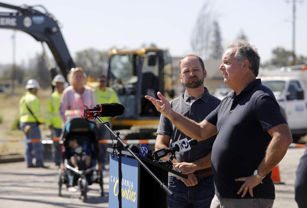 Tubbs fire survivors Phil Demery of Fountaingrove, right, and Brad Sherwood, of Larkfield, speak out against possible legislative changes to utility liability law during a press conference at 77 Chelsea Dr. in front of Sherwood's empty lot on Wednesday, July 11, 2018 in Santa Rosa, California . (BETH SCHLANKER/The Press Democrat)