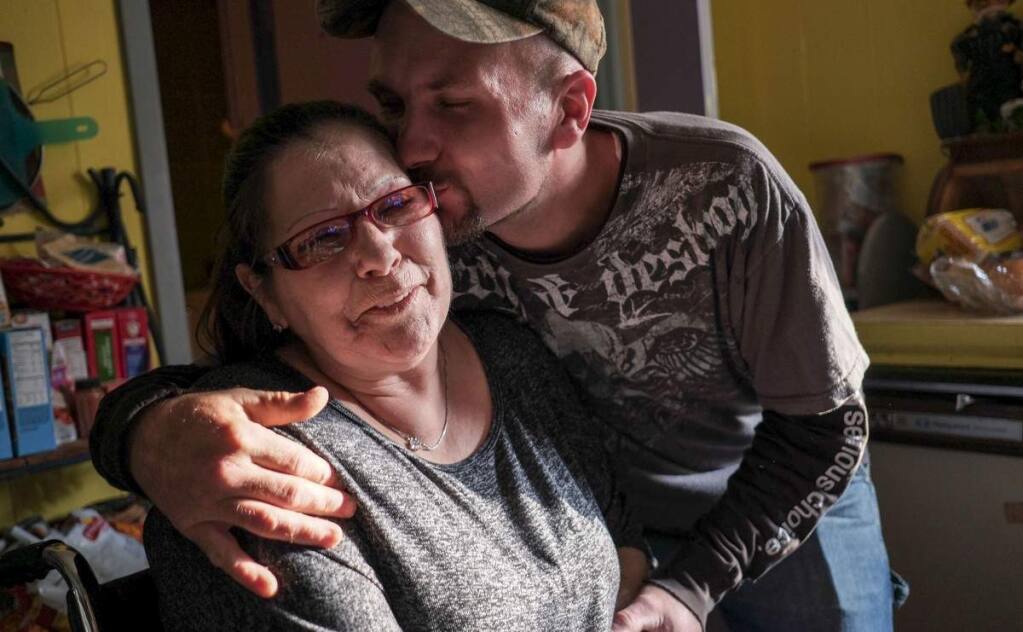 Desmond Spencer with his mother, Karen Rub, who is on disability, at their home in Beaverton, Alabama. Rural America experienced the most rapid increase in disability rates over the past decade, a Washington Post analysis has found. (BONNIE JO MOUNT / WASHINGTON POST)