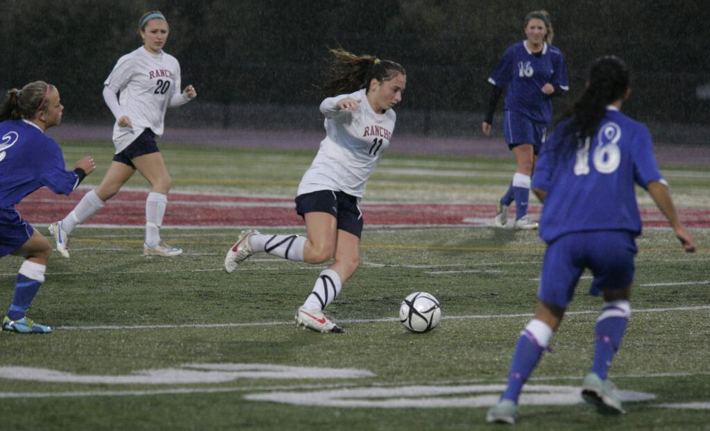 With rain pouring down Rancho Cotate's Mariah Meuse works her way down the field against Fortuna in the first half of their NCS Soccer playoff game at Rancho Cotate High School in Rohnert Park on Wednesday October 31, 2012. Scott Manchester / For The Press Democrat