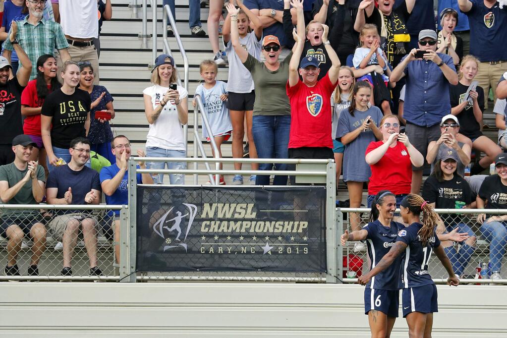 FILE - In this Oct. 27, 2019, file photo, North Carolina Courage's Jessica McDonald (14) celebrates her goal with Abby Erceg (6) during the first half of an NWSL championship soccer game against the Chicago Red Stars in Cary, N.C. There are just a handful of mothers who play professional soccer in the NWSL. But when the league asks players to travel to Utah and be sequestered for more than a month, moms' voices are important. North Carolina Courage forward Jessica McDonald, whose son Jeremiah is 8 years old. She spoke up new NWSL Commissioner Lisa Baird got the moms on a call to discuss the tournament. (AP Photo/Karl B DeBlaker,FIle)
