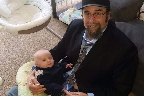 Kevin Sullivan, shown with a grandchild in an undated family photo posted on GoFundMe.