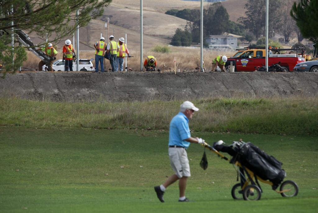 Dave Cramer plays golf at Rooster Run Golf Club as employees of Ghilotti Bros. Inc. build a new park on East Washington Street in Petaluma in 2014. (BETH SCHLANKER/ PD FILE)