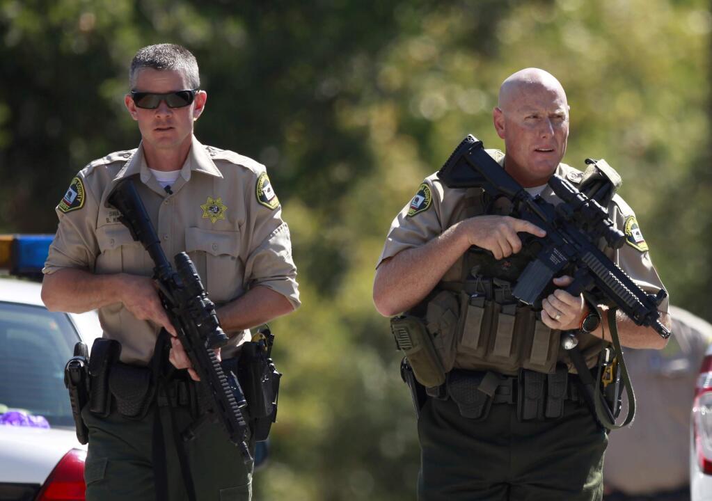 Sonoma County sheriff's deputies searched for other suspects after they arrested a young man near a home in the 9000 block of Starr Road in Windsor, California on Thursday, August 28, 2014. BETH SCHLANKER/ The Press Democrat)