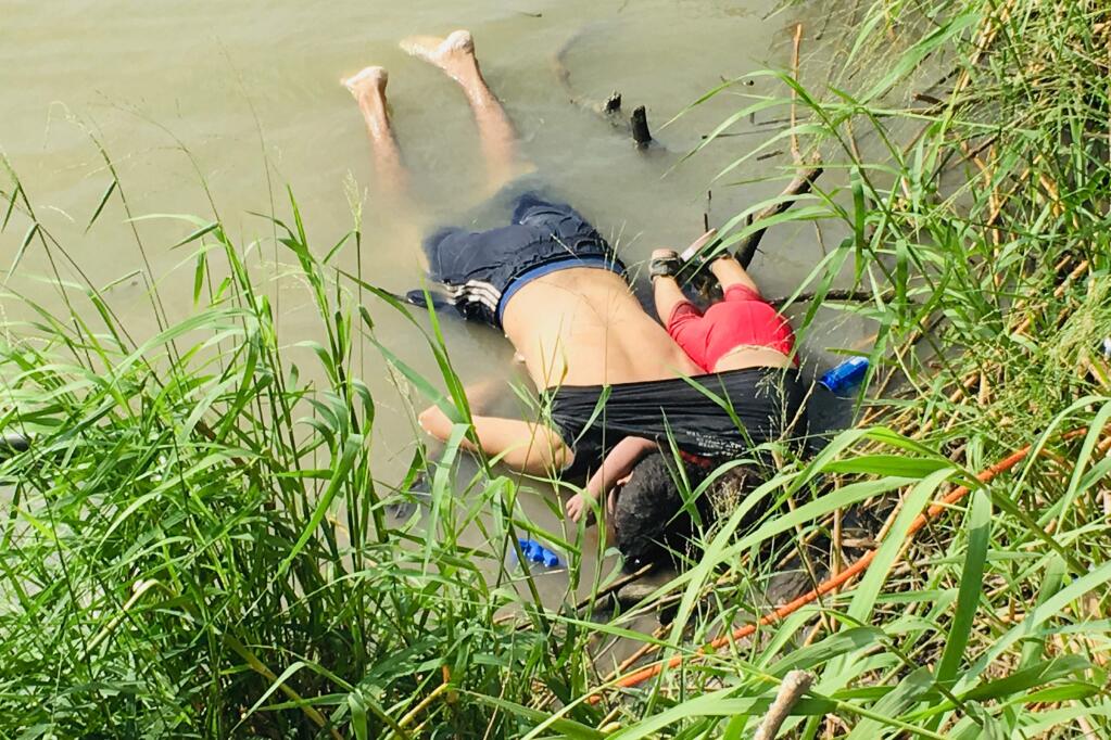 GRAPHIC CONTENT - The bodies of Salvadoran migrant Oscar Alberto Martínez Ramírez and his nearly 2-year-old daughter Valeria lie on the bank of the Rio Grande in Matamoros, Mexico, Monday, June 24, 2019, after they drowned trying to cross the river to Brownsville, Texas. Martinez' wife, Tania told Mexican authorities she watched her husband and child disappear in the strong current. This photograph was first published in the Mexican newspaper La Jornada. (AP Photo/Julia Le Duc)