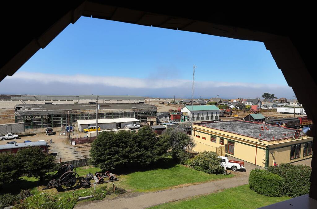 The Skunk Train Depot and old roundhouse sit adjacent to the large empty Georgia-Pacific Mill site, as seen from the Guesthouse Museum, in Fort Bragg. (Christopher Chung/ The Press Democrat)