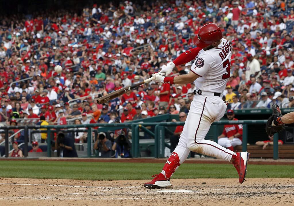 Washington Nationals' Bryce Harper hits a solo home run during the fourth inning of a baseball game against the San Francisco Giants at Nationals Park, Saturday, June 9, 2018, in Washington. (AP Photo/Alex Brandon)