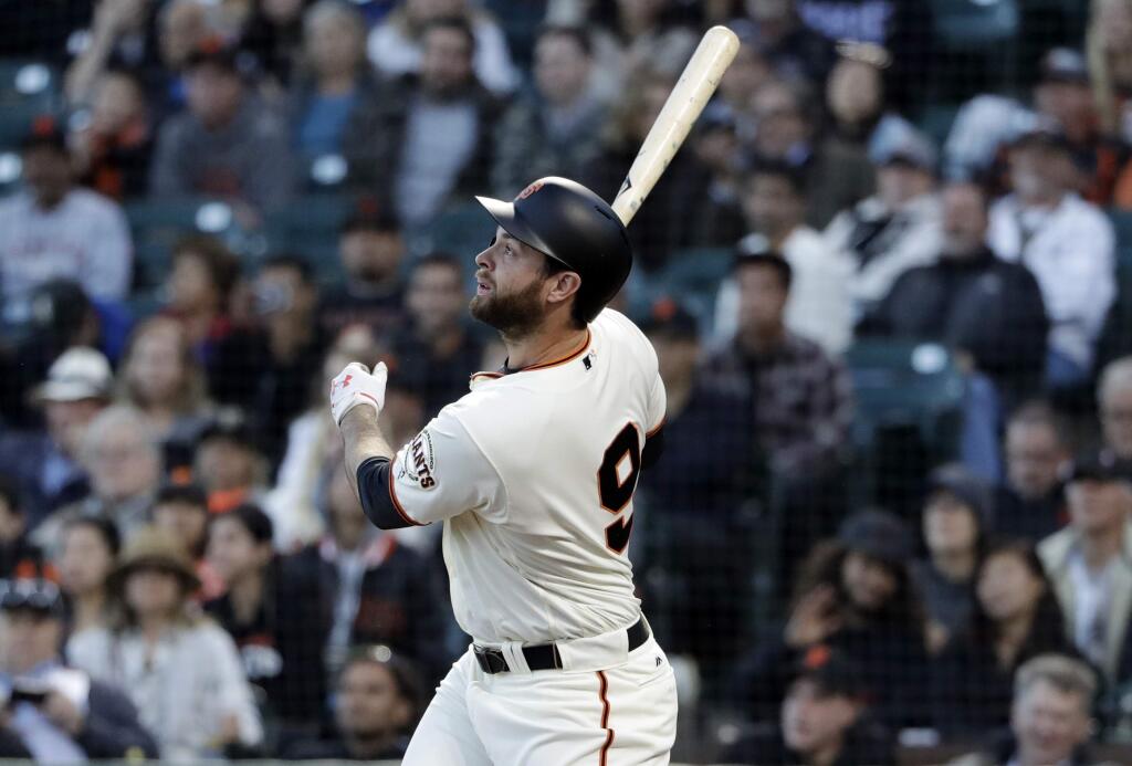 San Francisco Giants' Brandon Belt follows through as he drives in a run with a triple against the Colorado Rockies during the third inning of a baseball game, Monday, June 26, 2017, in San Francisco. (AP Photo/Marcio Jose Sanchez)
