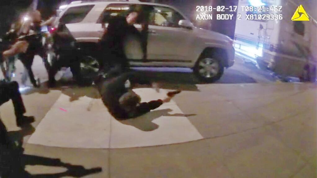 This Feb. 17, 2018, still frame from video from a San Francisco police officer's body camera shows several officers hitting the ground and firing multiple rounds into an RV after a person inside allegedly fired two shots at them in the city's Mission Bay district. No one was hit by the gunfire. The department has released several videos of the incident from officer's body cameras. (San Francisco Police Department via AP)
