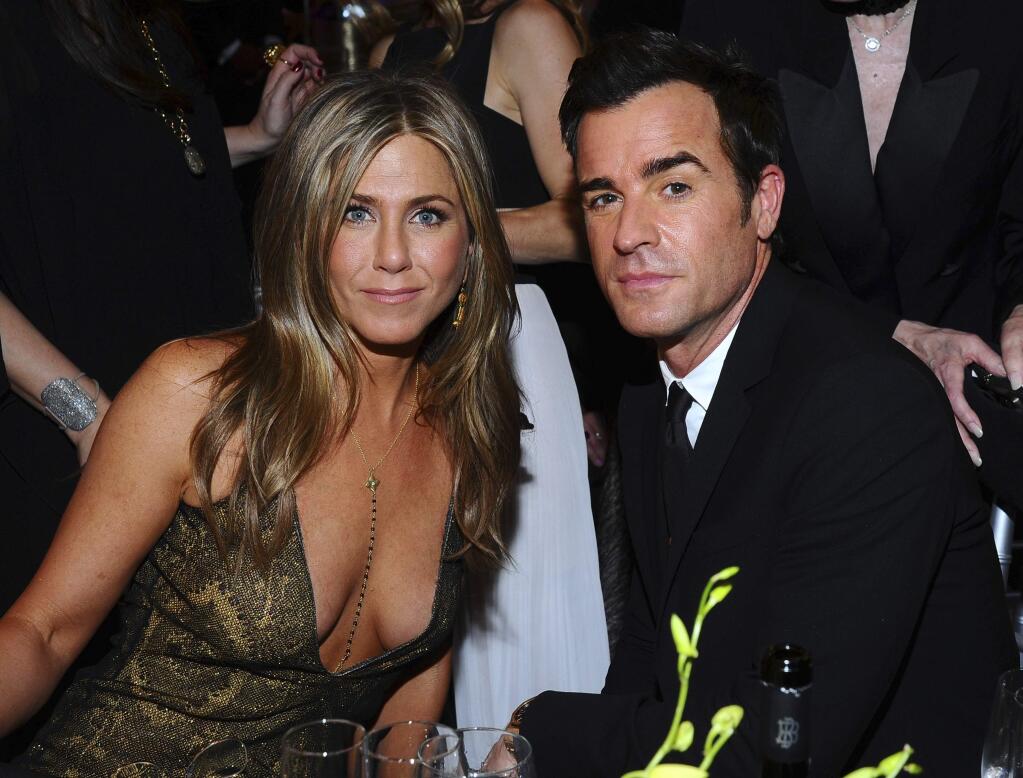 FILE - In this Jan. 25, 2015 file photo, Jennifer Aniston, left, and Justin Theroux pose in the audience at the 21st annual Screen Actors Guild Awards in Los Angeles. The couple announced Thursday, Feb. 15, 2018, that they have separated. (Photo by Vince Bucci/Invision/AP, File)