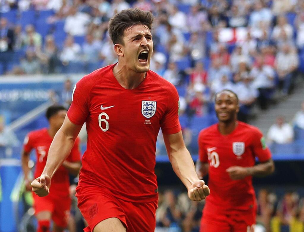 England's Harry Maguire celebrates after scoring his team's opening goal during the quarterfinal game between Sweden and England at the World Cup in the Samara Arena, in Samara, Russia, Saturday, July 7, 2018. (AP Photo/Francisco Seco)