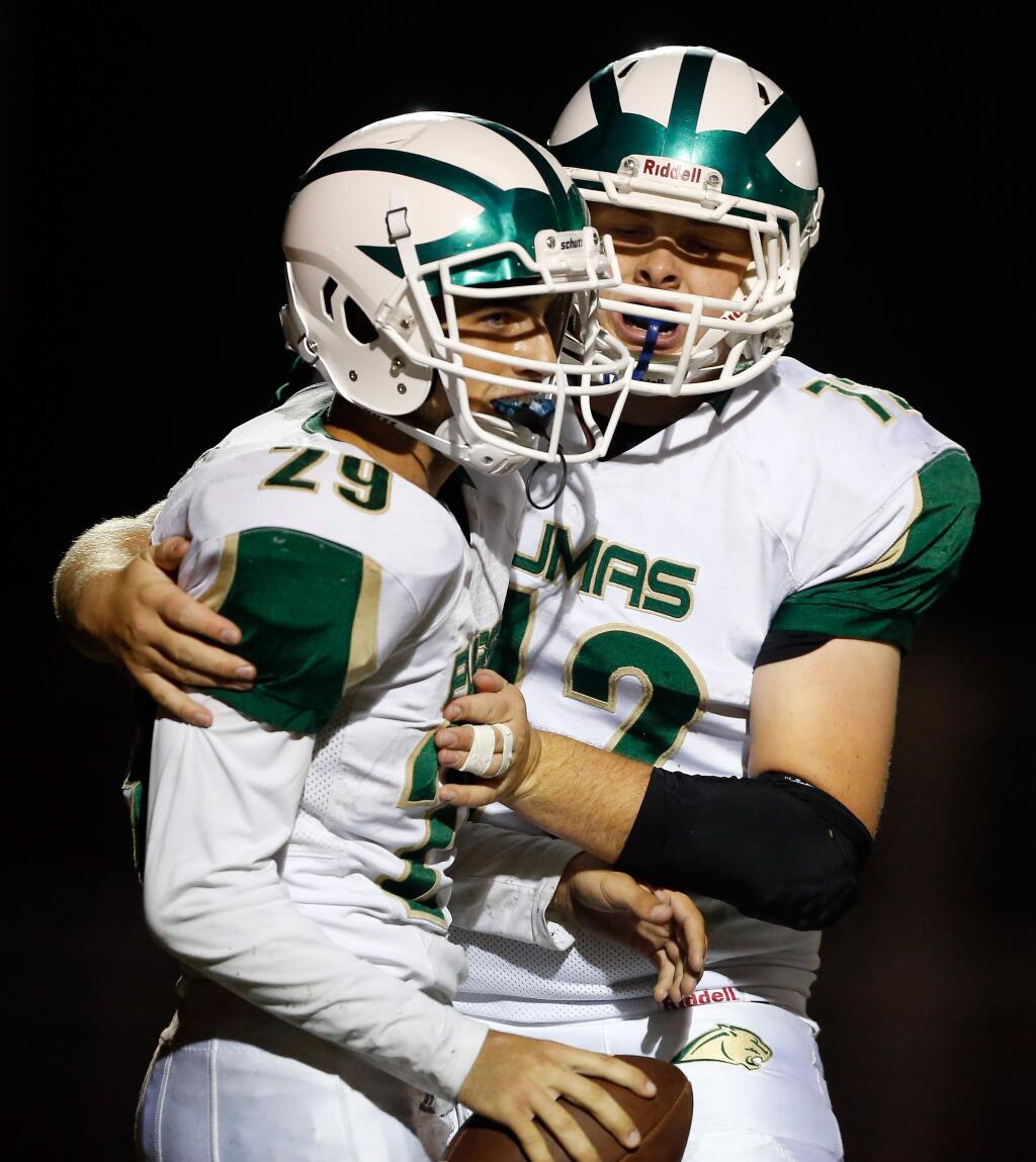 Maria Carrillo's Jack Sherman, left, is congratulated by teammate Jackson Petty during a 2018 game. Sherman scored the Pumas' only touchdown of their 34-6 loss to Benicia on Sept. 6, 2019. (Alvin Jornada / The Press Democrat)