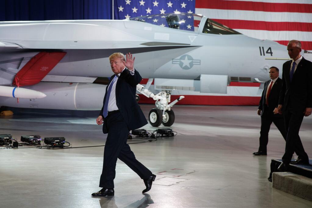 President Donald Trump waves as he walks off after participating in a roundtable discussion on tax policy at the Boeing Company, Wednesday, March 14, 2018, in St. Louis. (AP Photo/Evan Vucci)