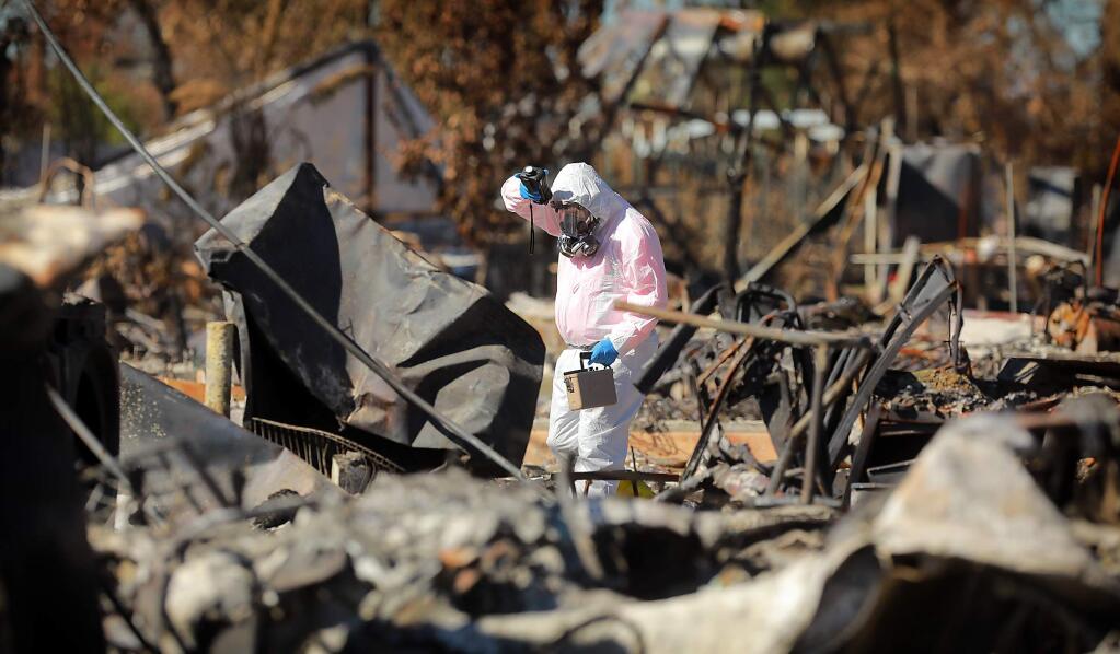 Five days after residents were allowed to sort through the ashes of their homes in the Coffey Park area of Santa Rosa, EPA hazardous materials survey teams check for radiation, volatile organic compounds and mercury vapor on Wednesday, October 25, 2017. (photo by John Burgess/The Press Democrat)