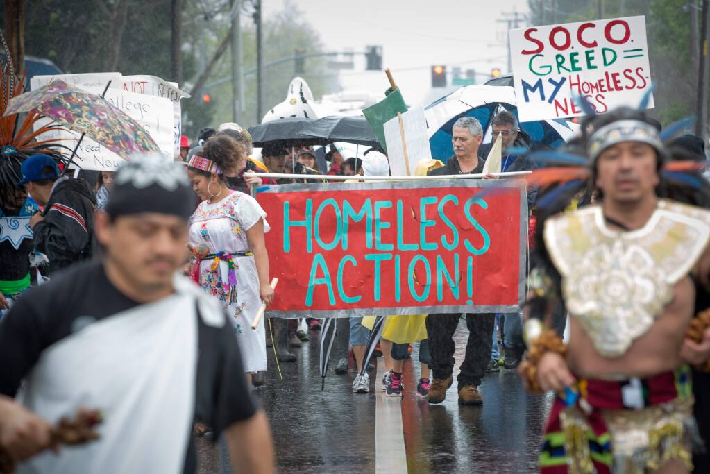 Members of the homeless population and community members march towards Old Courthouse Square in Santa Rosa Sunday, March 20, 2016 calling attention to the plight of thousands who live in Sonoma county without shelter.
